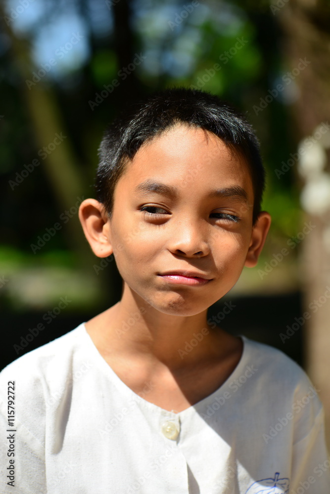 unhappy Asian boy in white shirt with nature unhappy Asian boy in white shirt with nature