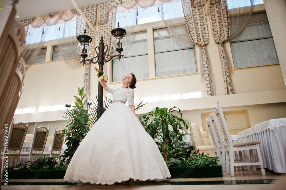 Portrait of beautiful bride at wedding hall background lantern