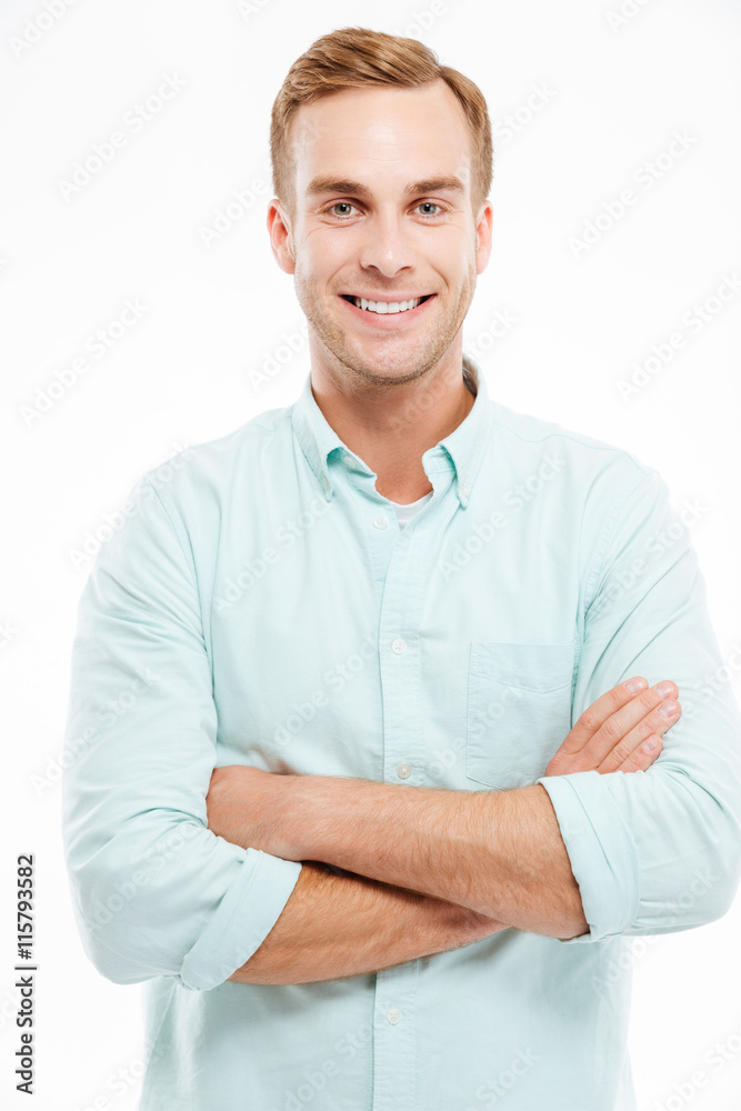 Portrait of a happy casual man standing with arms folded Portrait of a happy casual man standing with arms folded