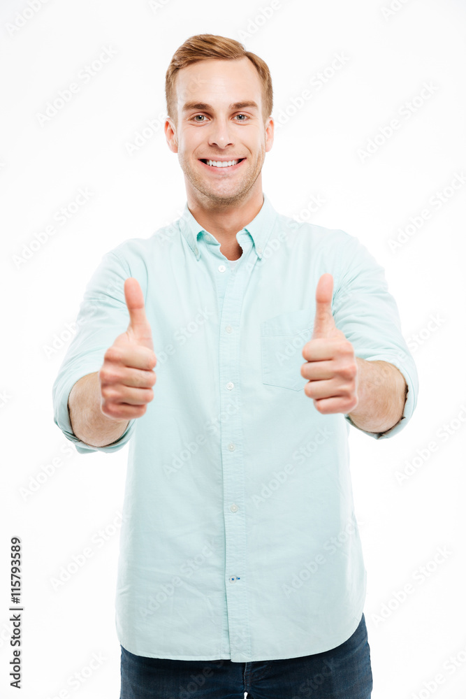 Portrait of a smiling casual man showing two thumbs up Portrait of a smiling casual man showing two thumbs up