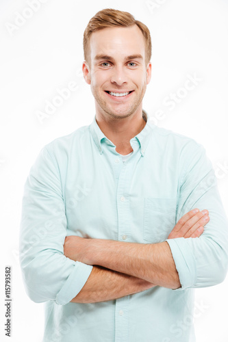 Portrait of a happy casual man standing with arms folded © Drobot Dean