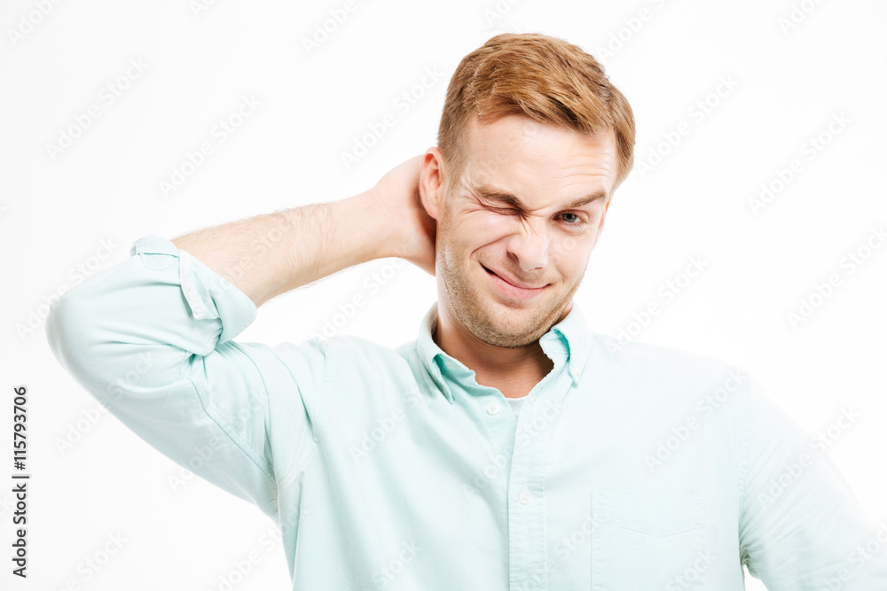 Lazy handsome young businessman standing and scratching his head Lazy handsome young businessman standing and scratching his head
