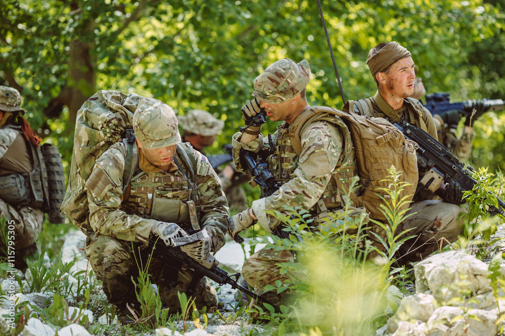 Special forces soldiers with weapon take part in military maneuv Special forces soldiers with weapon take part in military maneuv
