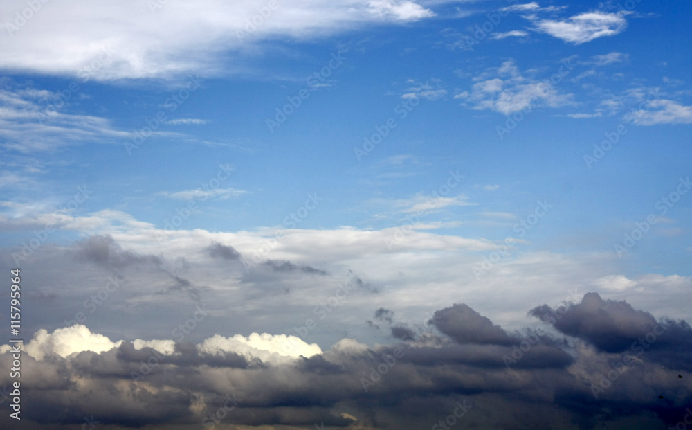 Blue sky above thunder clouds.