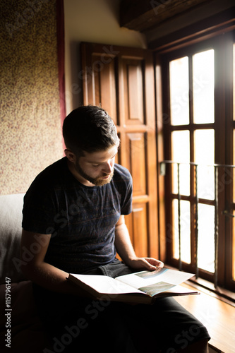 Man reading a book at home