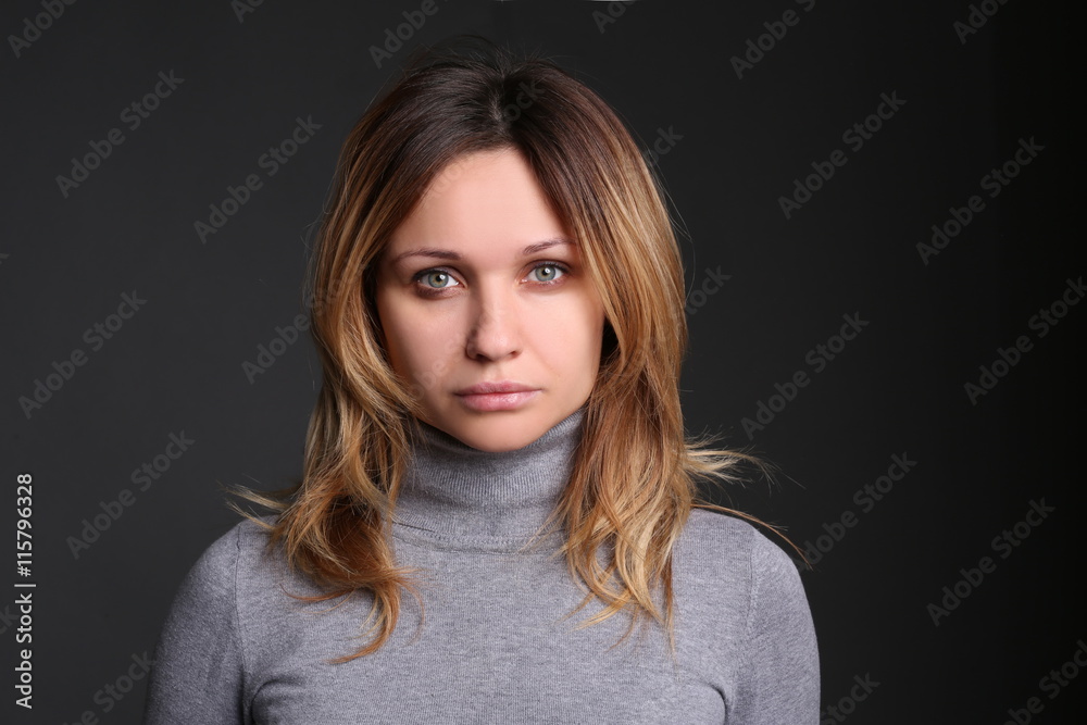 Portrait of beautiful young woman against black background in studio Portrait of beautiful young woman against black background in studio