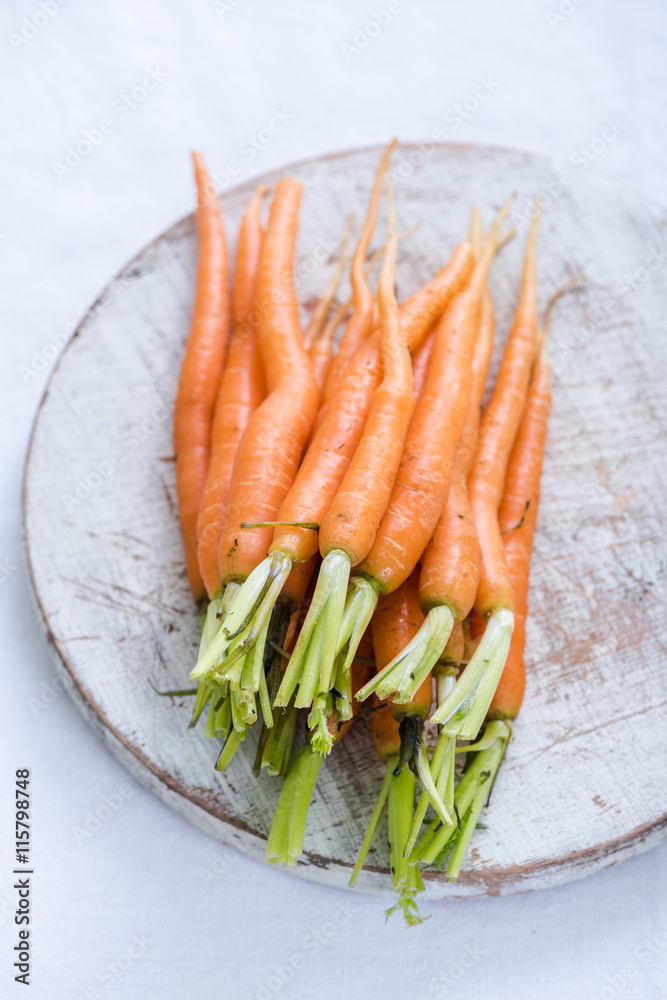 young vibrant carrots on rustic board young vibrant carrots on rustic board