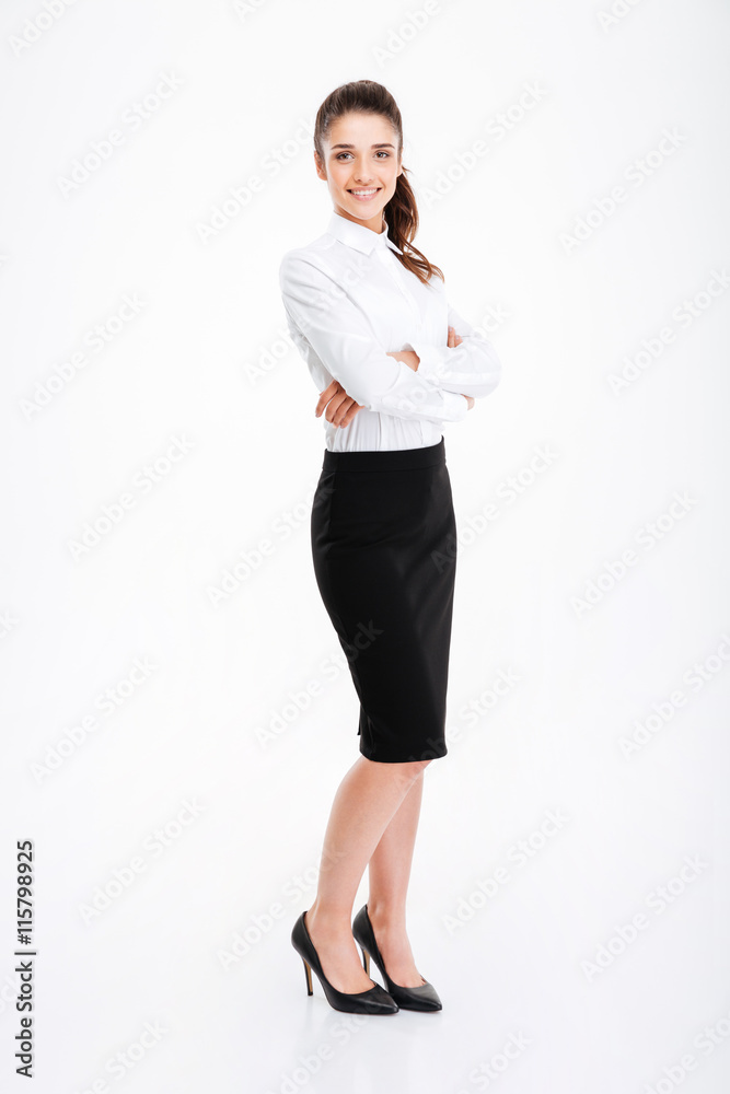 Full length portrait of a businesswoman standing with arms folded Full length portrait of a businesswoman standing with arms folded