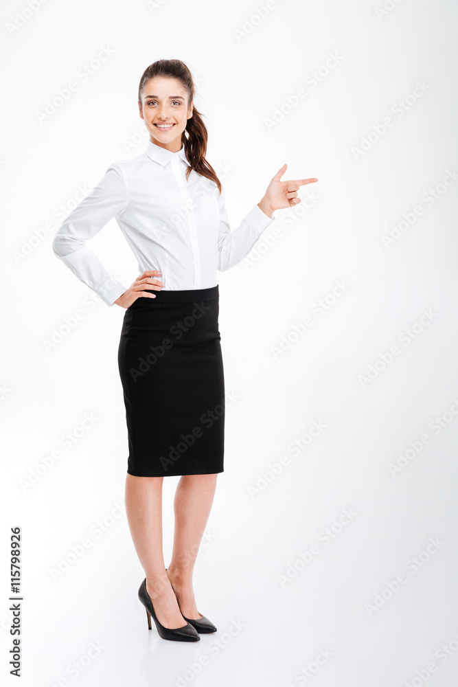 Cheerful businesswoman pointing finger away over white background Cheerful businesswoman pointing finger away over white background