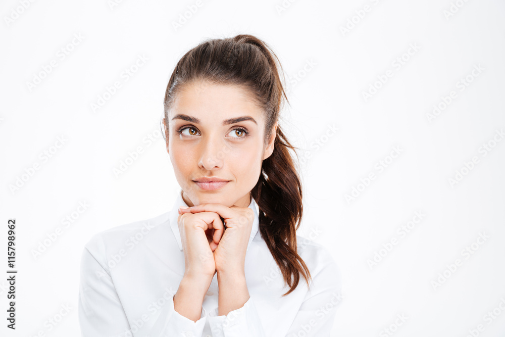 Thinking business woman smiling and looking up at copy space Thinking business woman smiling and looking up at copy space