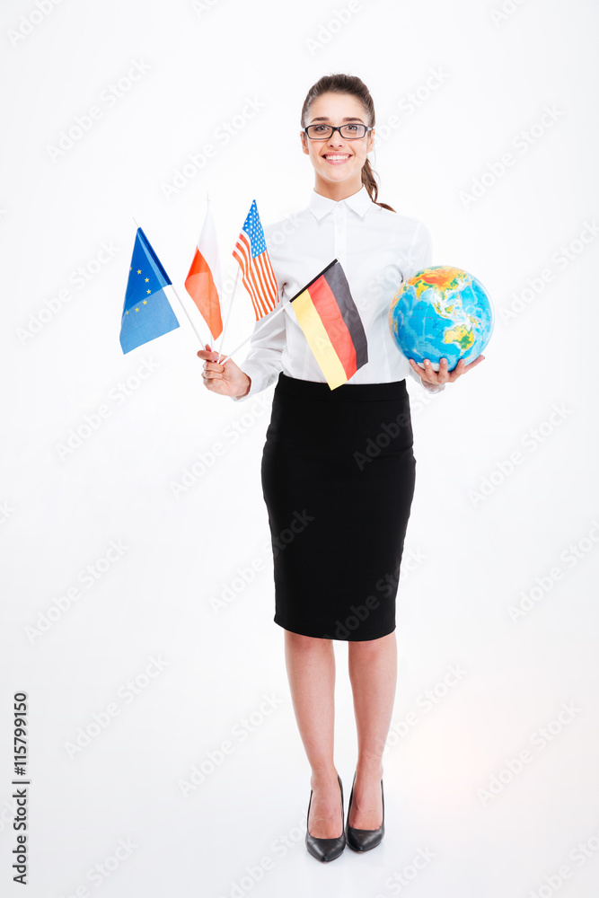 Fototapeta premium Happy young businesswoman holding flags of several countries and globe