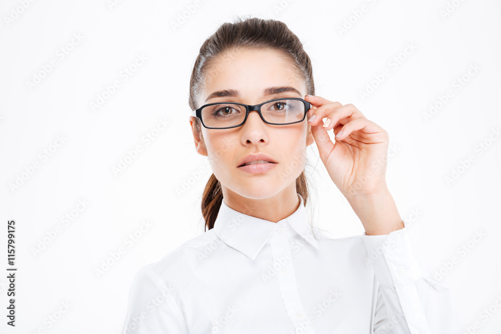 Closeup of serious beautiful young businesswoman in glasses
