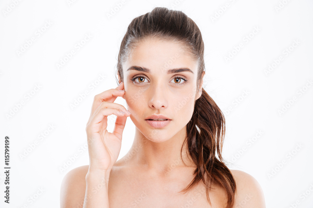 Beauty portrait of attractive young woman touching her face