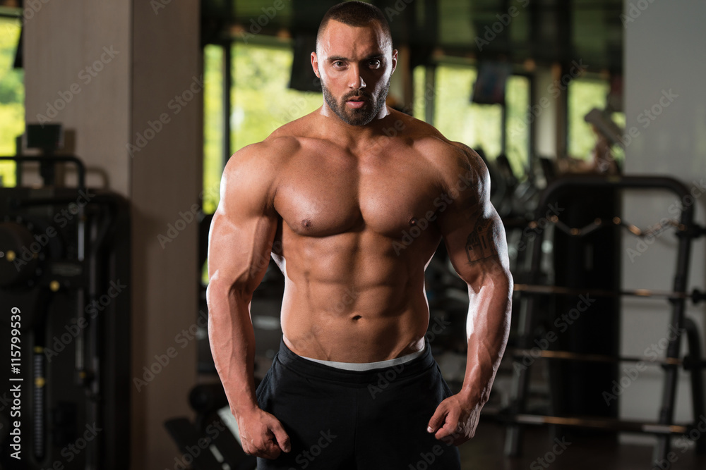 Athlete Muscular Bodybuilder Posing In The Gym