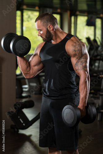 Bodybuilder Exercise Biceps With Dumbbells