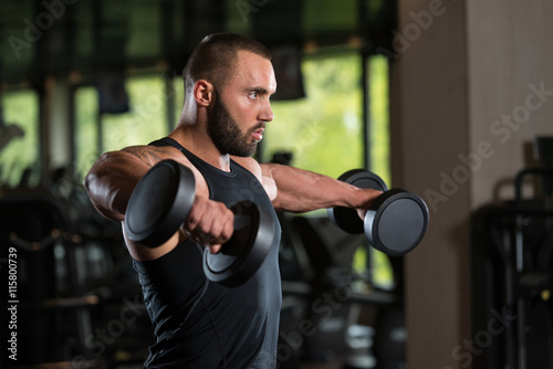 Bodybuilder Exercise Shoulders With Dumbbells © Jale Ibrak