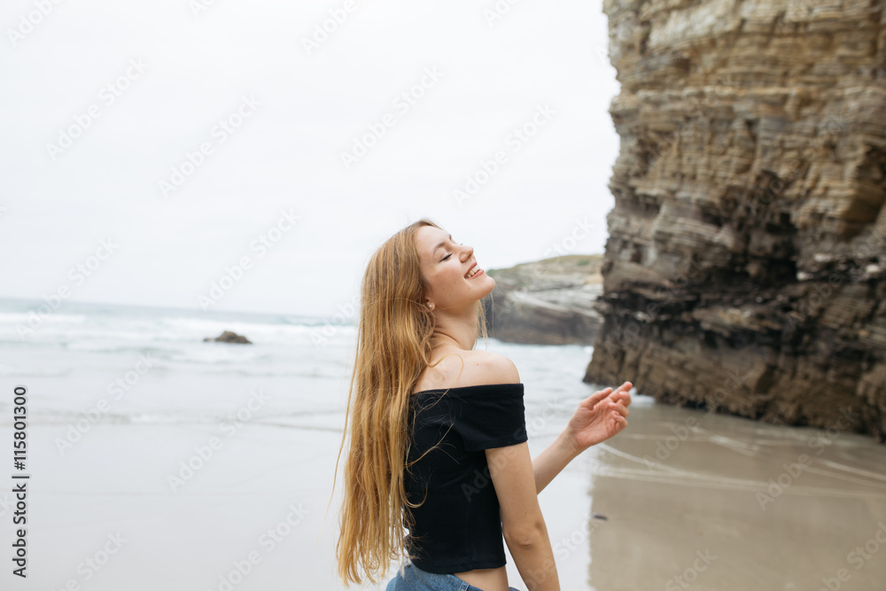 Beautiful young girl smiling at beach.