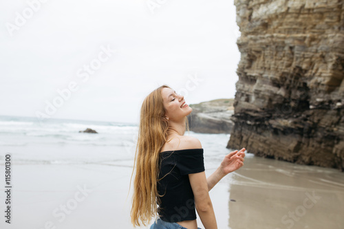 Fototapeta Naklejka Na Ścianę i Meble -  Beautiful young girl smiling at beach.