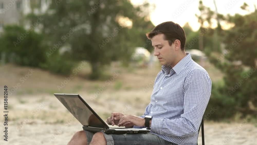 Young Business Man Working Remotely on Beach Young Business Man Working Remotely on Beach