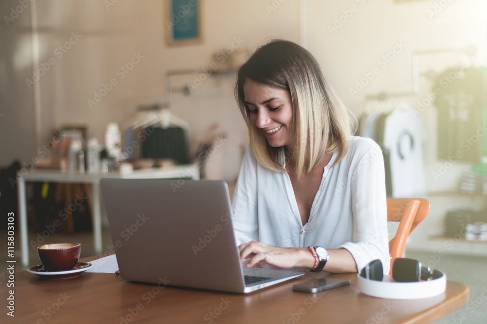 Young woman freelancer looking to the window