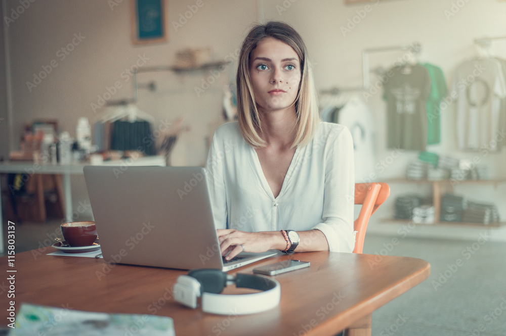 Young woman freelancer looking to the window