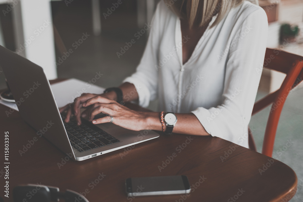 Young woman freelancer looking to the window