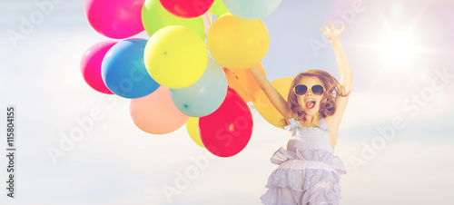 happy jumping girl with colorful balloons