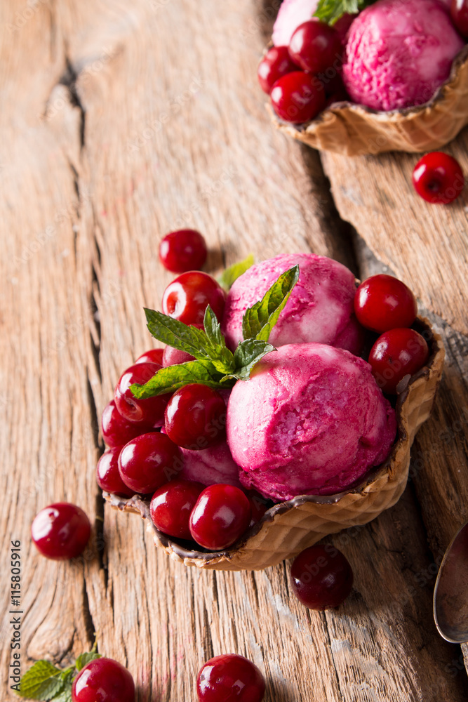 Sour cherry sundae with fresh fruits on wooden background. Sweet and summer concept