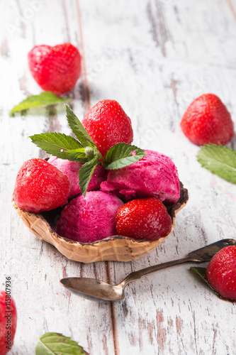 Sundae strawberry  ice cream with fresh berry fruits on wooden background