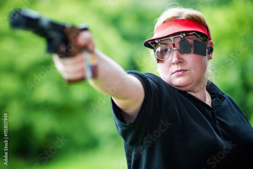Fototapeta Naklejka Na Ścianę i Meble -  Pistol sport shooting woman