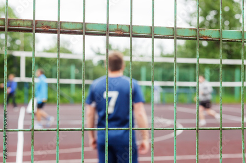 Fototapeta Naklejka Na Ścianę i Meble -  Athletes train behind the fence in a closed area
