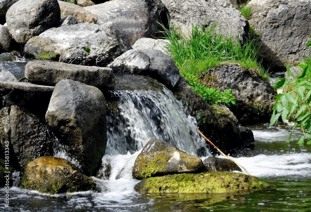 Rapids between rocks at the mountain river  