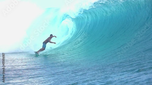 SLOW MOTION: Extreme surfer surfing inside big tube barrel wave photo