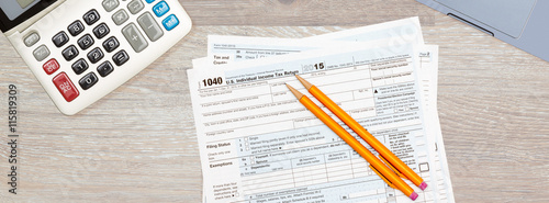 Laptop and calculator on 2015 IRS form 1040