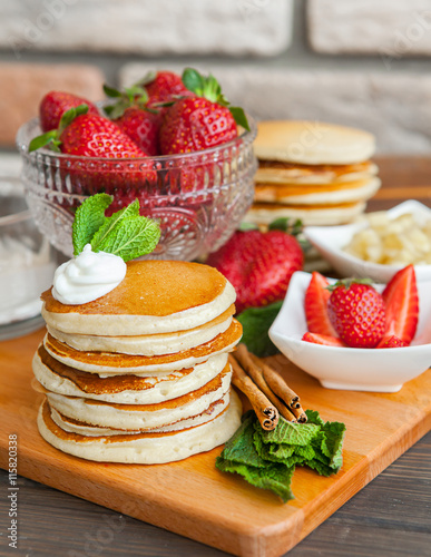 Pancakes on a wooden table with berries