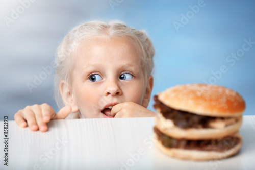 Funny little girl hiding be...