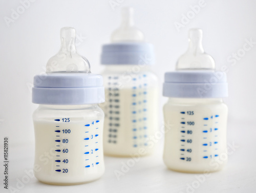 Baby milk bottles on white background
