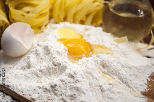 Flour and Egg on the wooden table at a kitchen