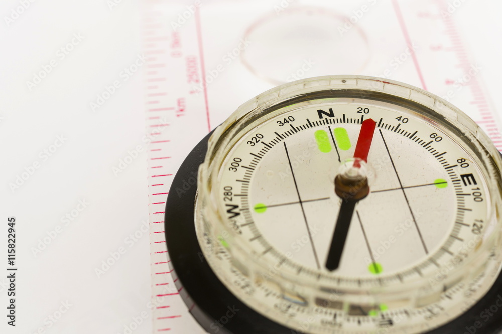 Detail shot of a glass compass on white background Detail shot of a glass compass on white background