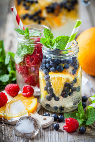 Cold drinks with straws - blueberry with orange and raspberries