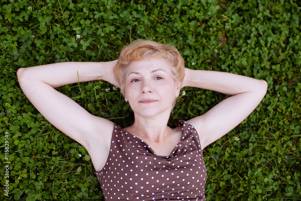 Portrait of middle aged woman smiling in the park Portrait of middle aged woman smiling in the park