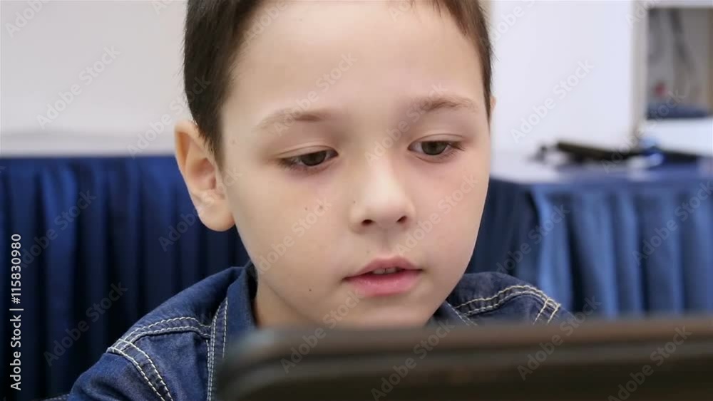 beautiful boy playing the tablet, slow motion beautiful boy playing the tablet, slow motion