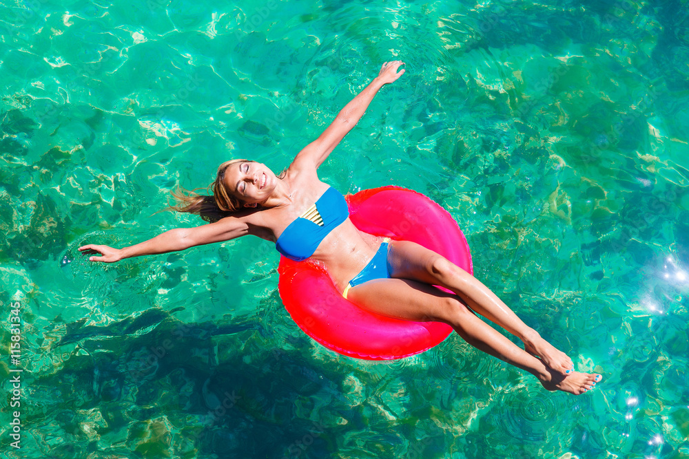 Happy beautiful young girl in bikini on a tropical beach. Blue s