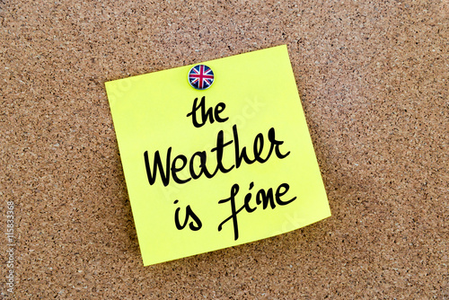 Yellow paper note pinned with Great Britain flag thumbtack and text The Weather Is Fine
