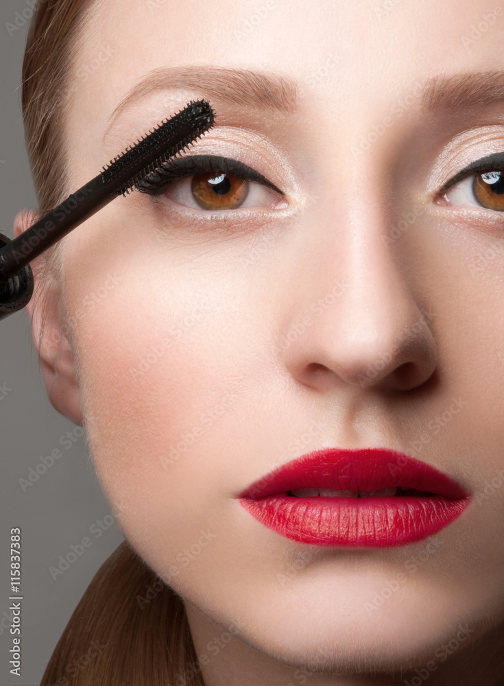 Woman eyes with beautiful makeup and long eyelashes. Mascara Brush