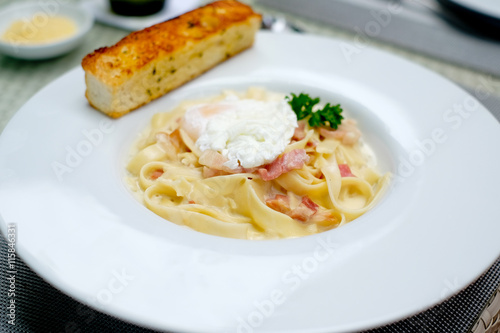 Carbonara Spaghetti  with  bacon and egg on white plate