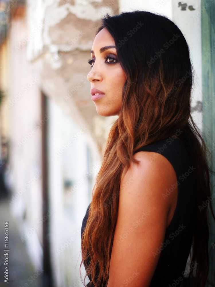 Summer outfit - beautiful African Italian woman, dressed with black and bronze dress, black High heeled shoes and black bag. Summer outfit - beautiful African Italian woman, dressed with black and bronze dress, black High heeled shoes and black bag.