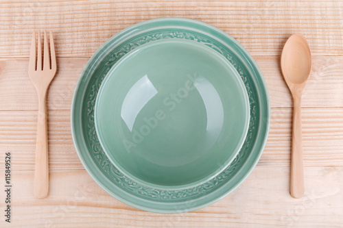 Empty caramic celadon dish and spoon fork photo