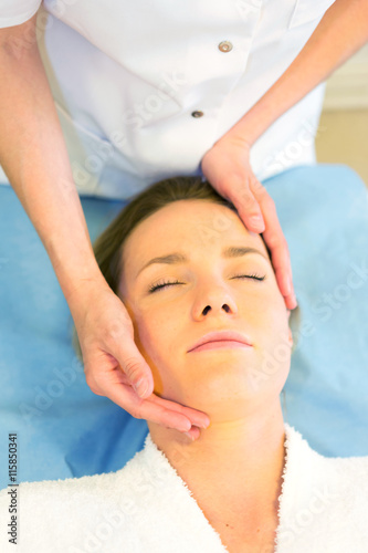 Detail of a woman face receiving a relaxing facial massage