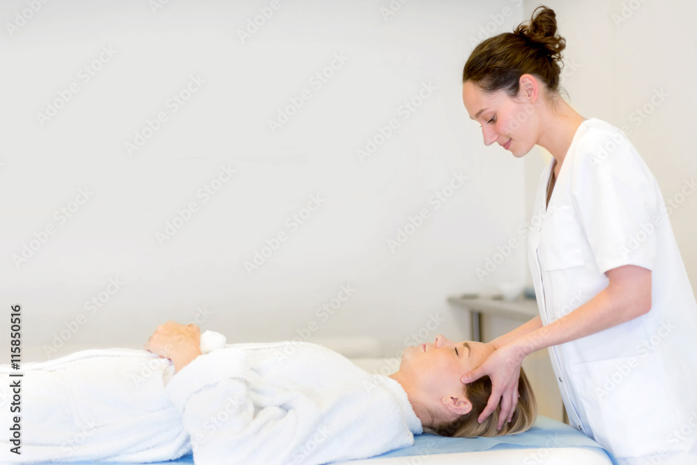 Young attractive masseuse doing a capillariy massage